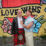 Posing in front of mural at Pizza Corner near Happily Hitched Halifax