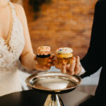 Couple holding cupcakes at Happily Hitched Halifax