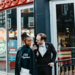 Couple in a post-ceremony photoshoot at Pizza Corner outside Happily Hitched Halifax