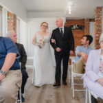 Bride being walked down the aisle by her father at Happily Hitched Halifax
